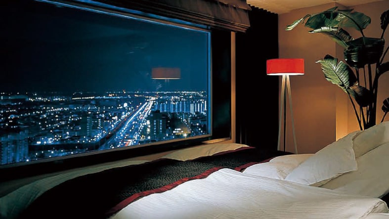 A bed facing the window in a guest room at Brighton Tokyo Bay hotel