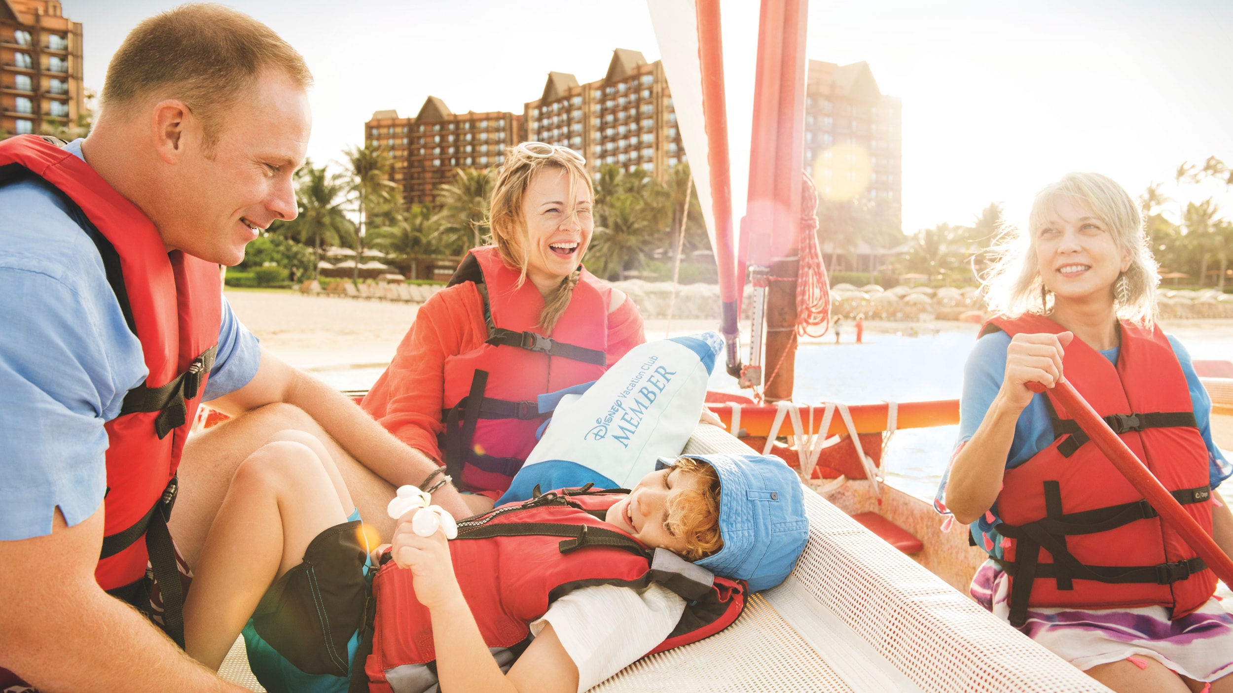 A family of 4 on a small boat in the lagoon at Aulani